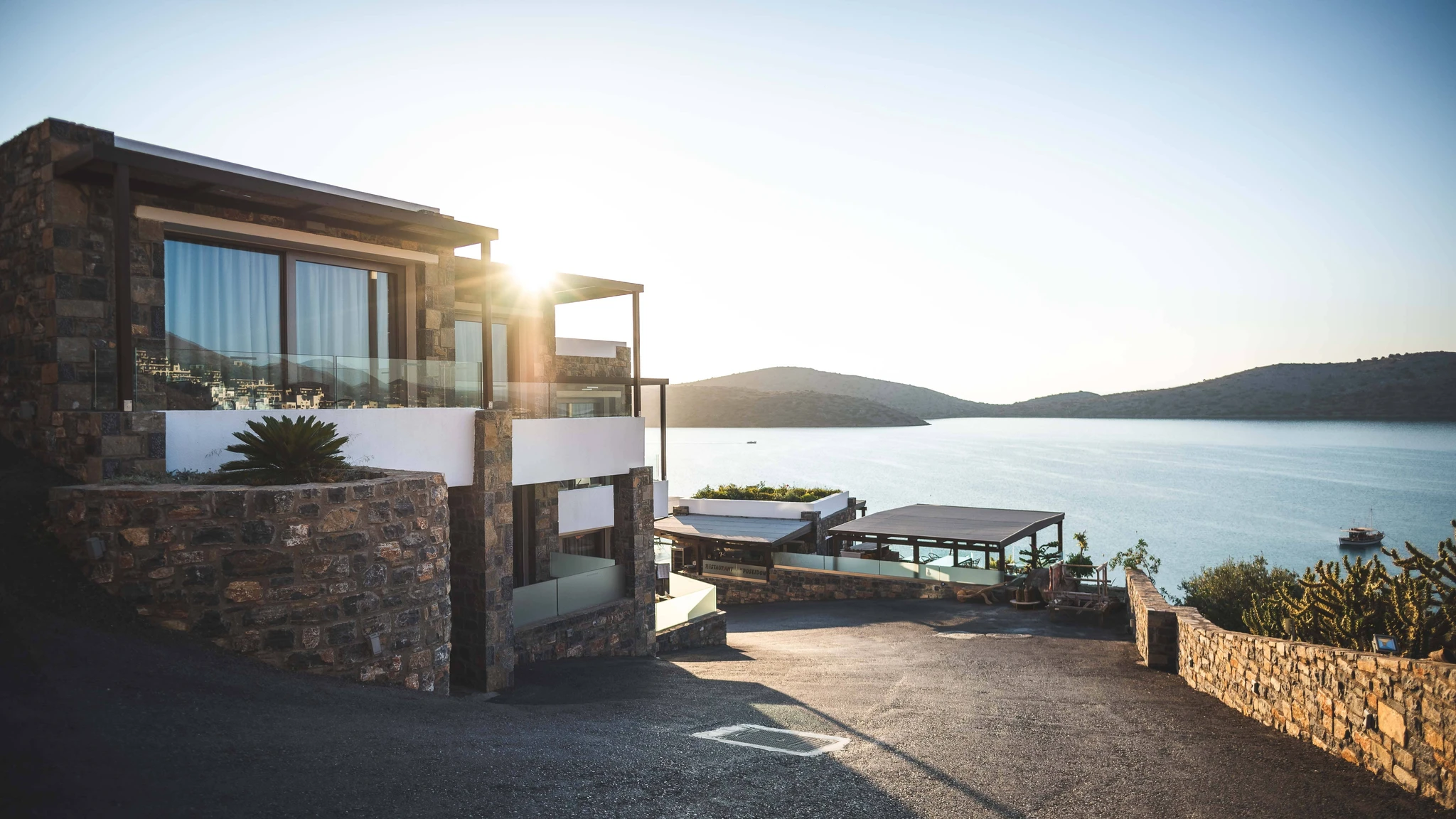 A modern house on a coast in the sunset.